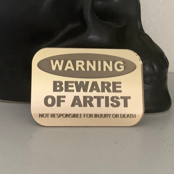 WARNING - Beware of Artist badge by Darcell Apelu